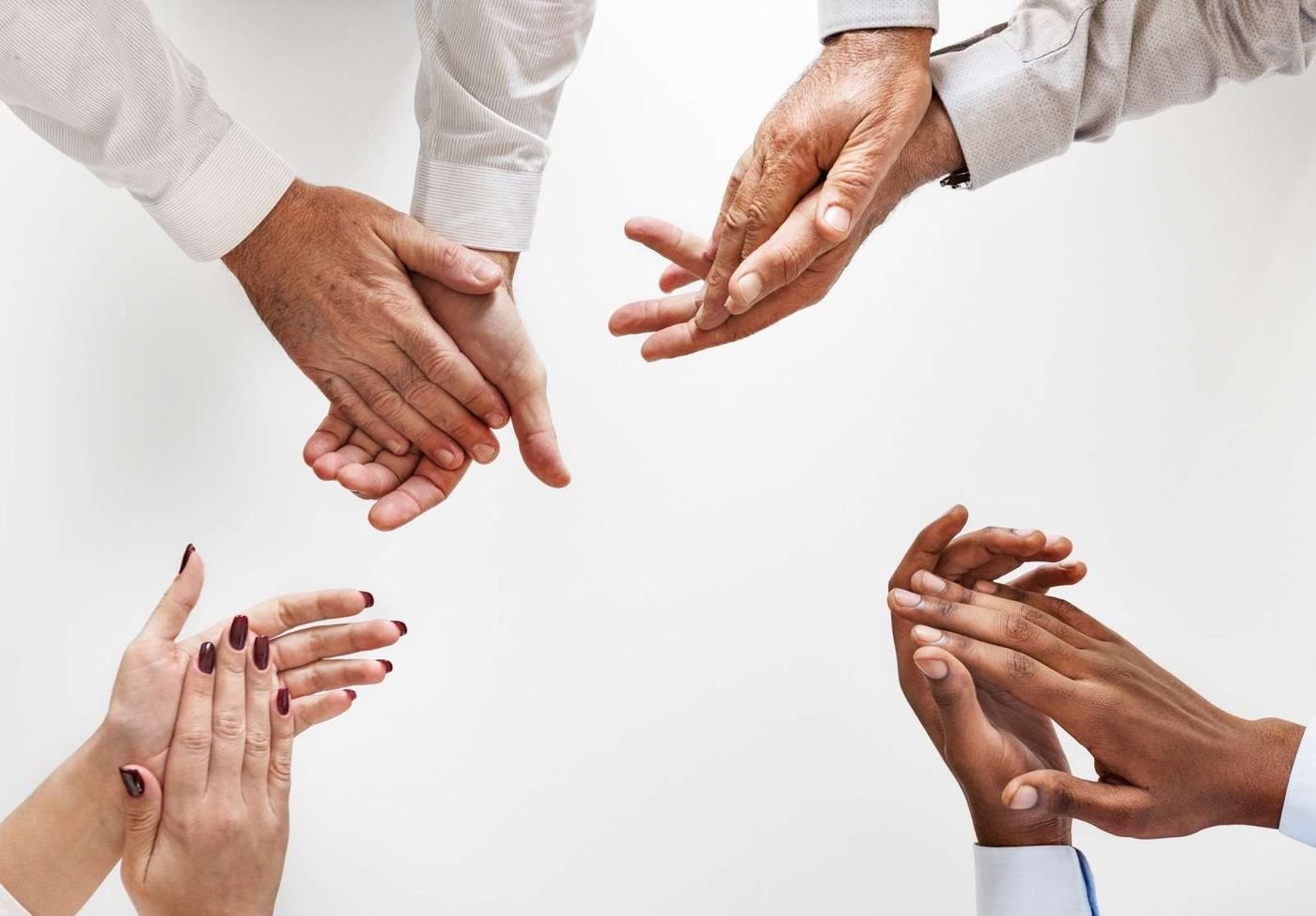 Team members applauding together around a table